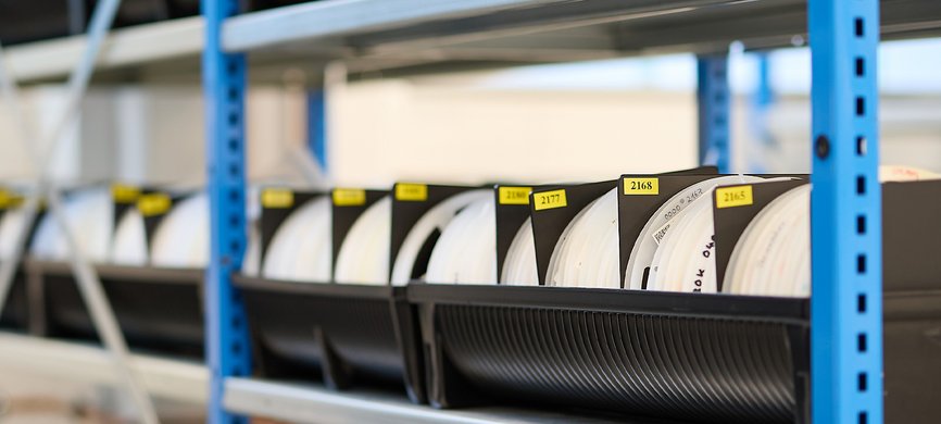 Lagerung von SMD Bauteilrollen bei GLÜCK Industrie-Elektronik im Rahmen der E²MS Elektronikfertigung.